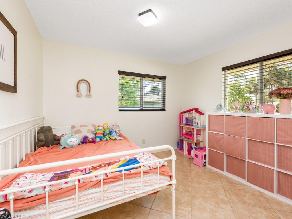 5300 Cypress Lane Naples, FL 34113 - Photo 9 of 14 a bedroom with a bed and a window