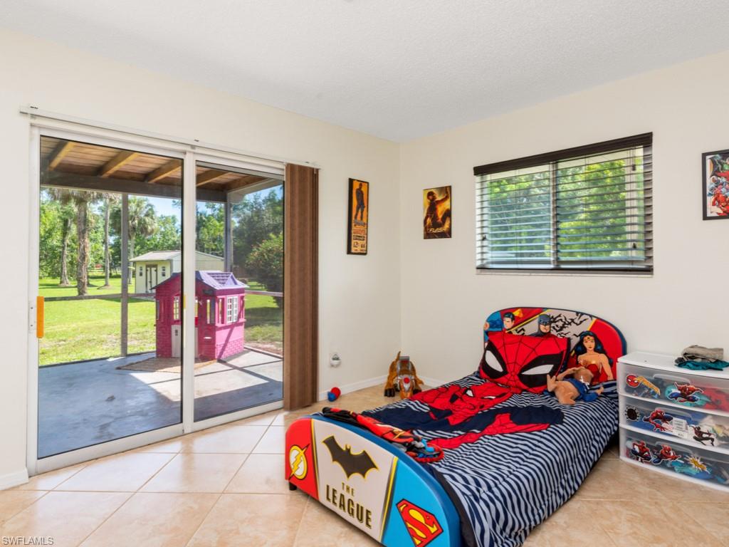 5300 Cypress Lane Naples, FL 34113 - Photo 10 of 14 a bedroom with a bed and a window