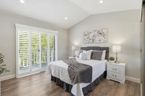 a bedroom with a large bed and a large window