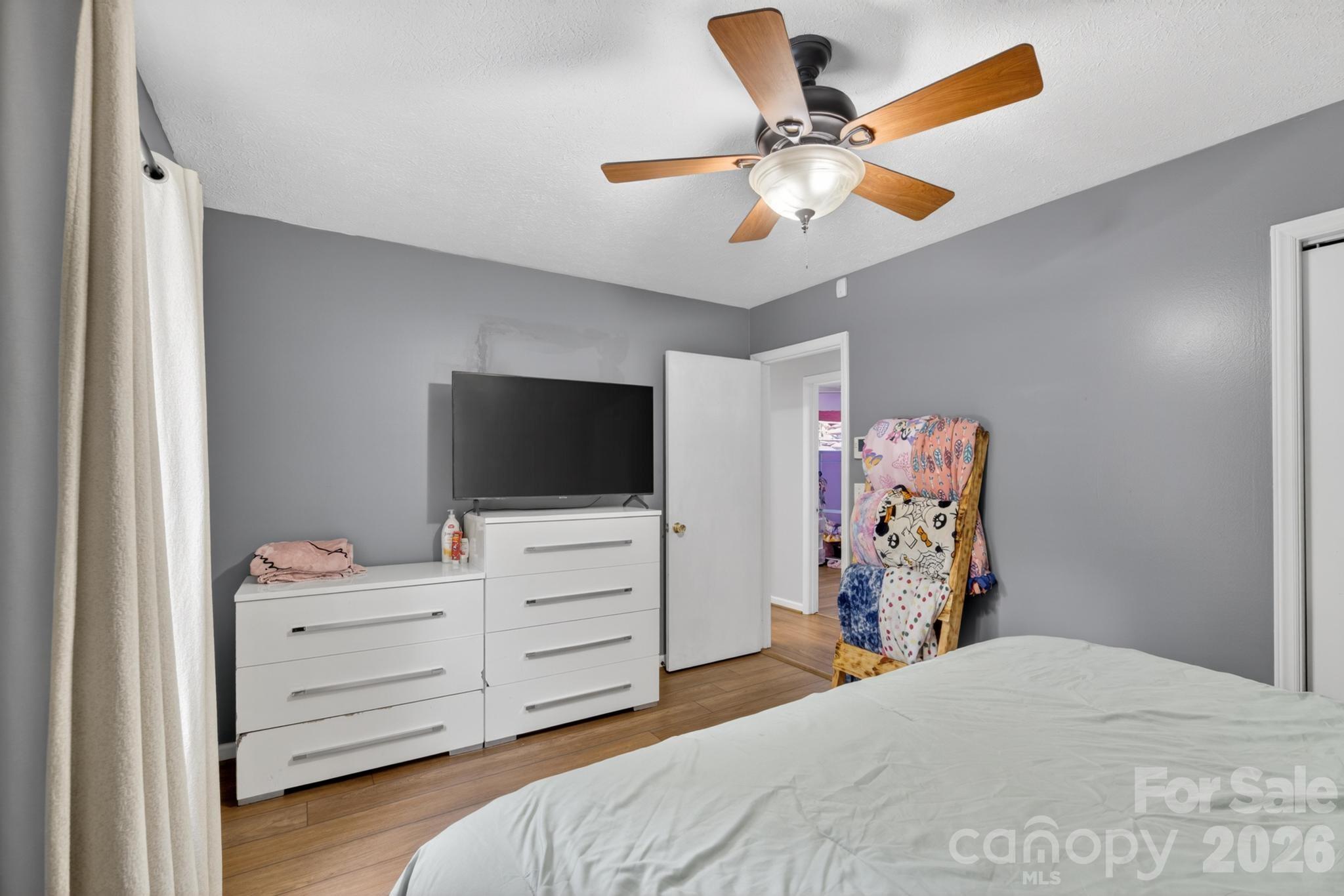 2308 Walt Arney Road Lenoir, NC 28645 - Photo 18 of 37 a bedroom with a bed and a flat screen tv