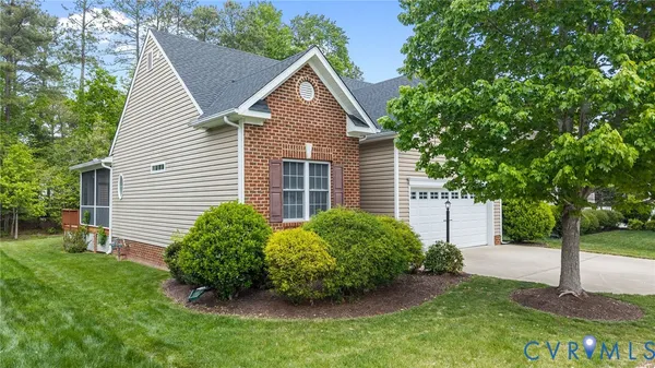 a view of a house with a yard and a garden