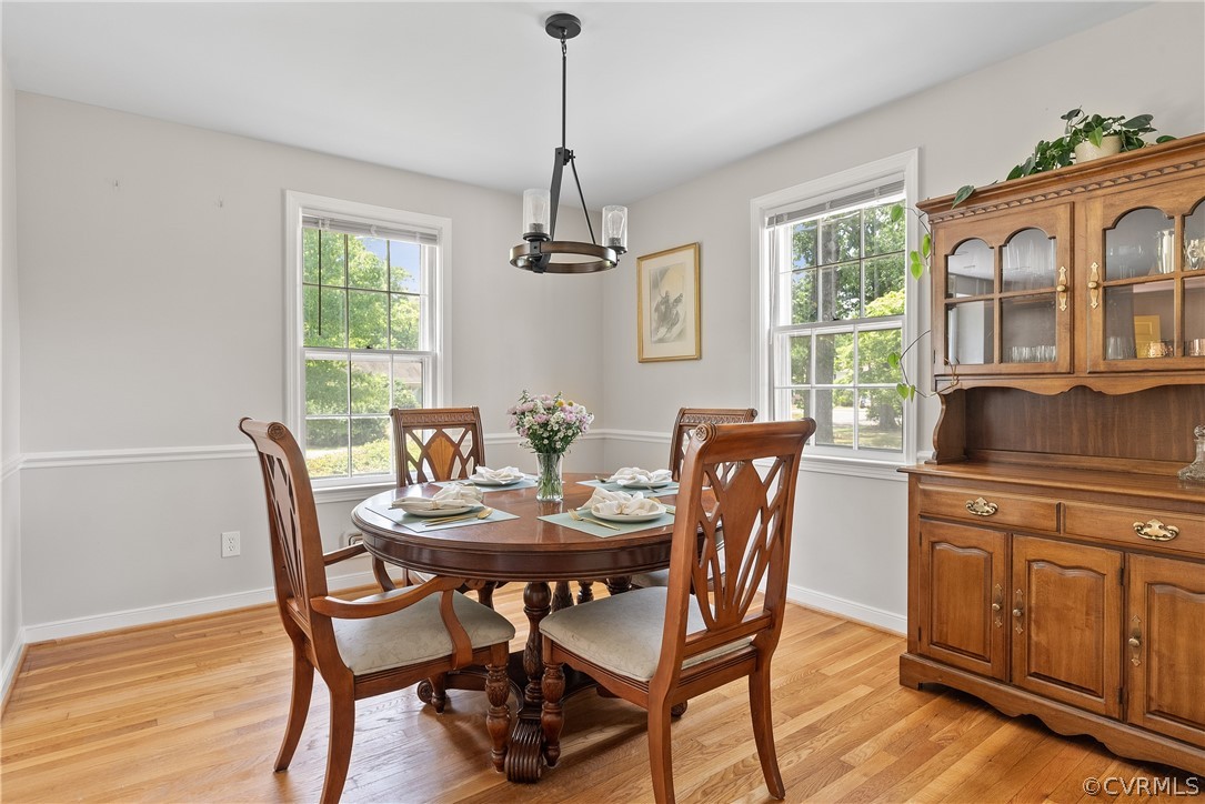 3121 Yukon Road Richmond, VA 23235 - Photo 13 of 27 a dining room with furniture a chandelier and wooden floor