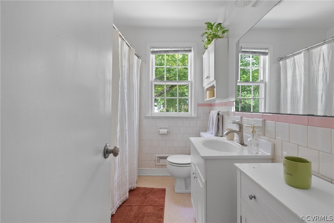 3121 Yukon Road Richmond, VA 23235 - Photo 18 of 27 a bathroom with a sink a toilet and a window
