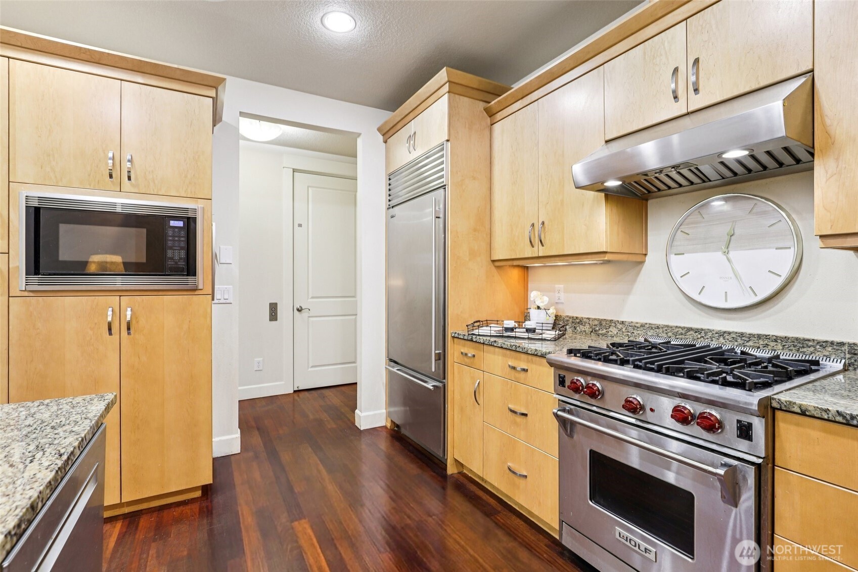 7812 Northwest Quinault Street, Unit 5 Camas, WA 98607 - Photo 13 of 40 a kitchen with granite countertop a stove and a wooden cabinets
