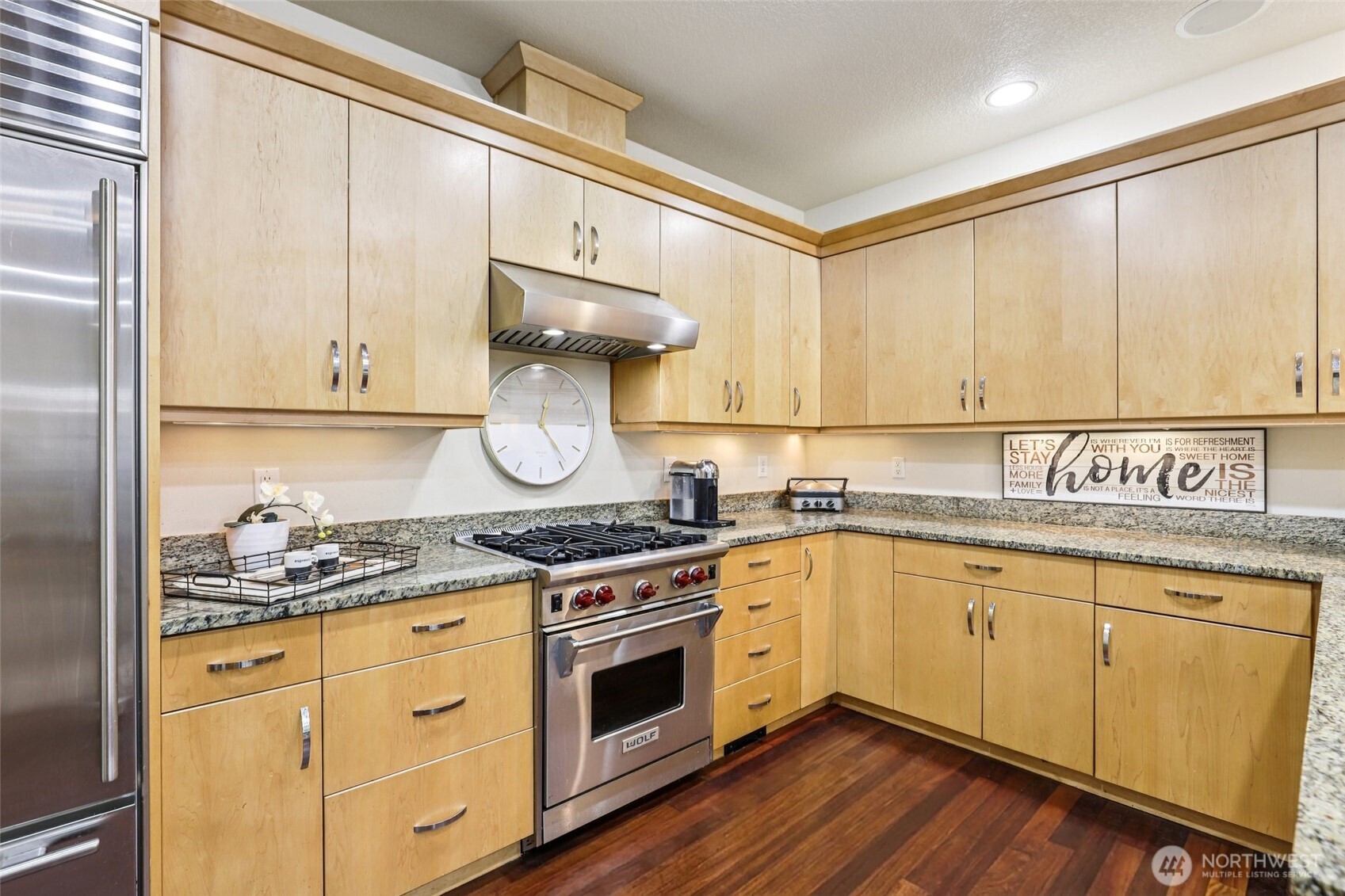 7812 Northwest Quinault Street, Unit 5 Camas, WA 98607 - Photo 10 of 40 a kitchen with stainless steel appliances granite countertop a stove and white cabinets