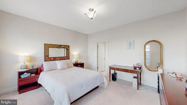 a bedroom with bed and a chandelier