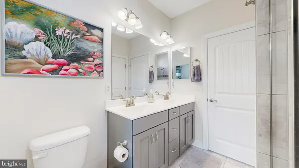 a bathroom with a sink vanity and a mirror