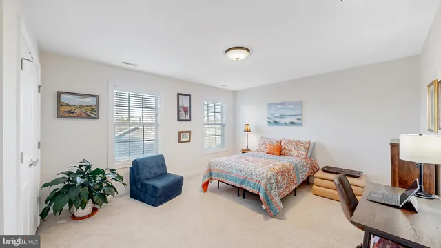 a bedroom with a bed and a potted plant