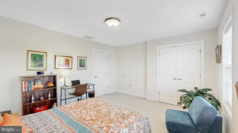 a bed room with a bed and a chair