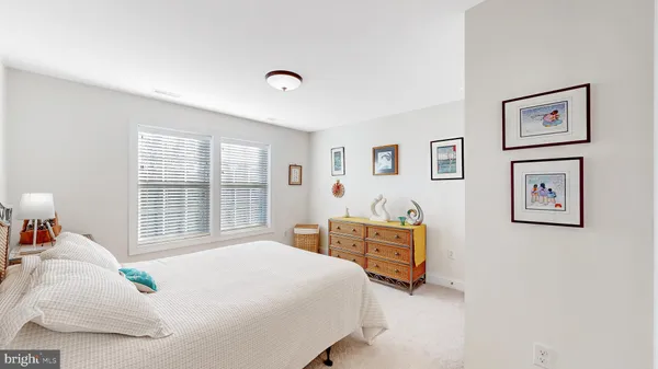 a bed room with a bed and a chair