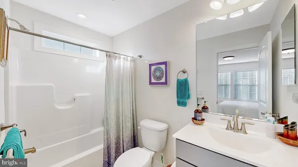 a bathroom with a sink toilet tub and shower