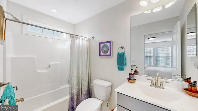 a bathroom with a sink toilet tub and shower