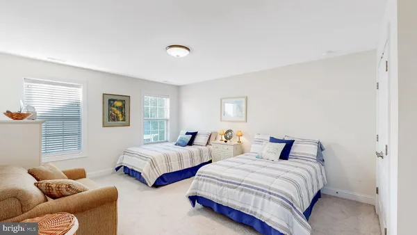 a bedroom with two beds and a couch