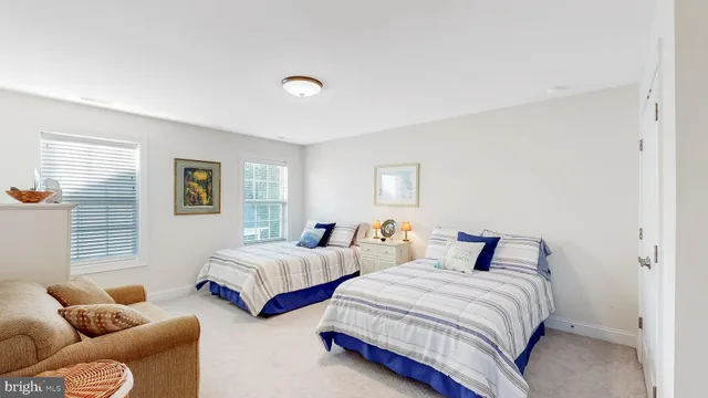 a bedroom with two beds and a couch