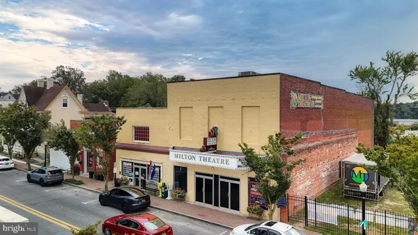 a front view of a house with garage and balcony