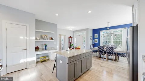 a room with a dining table wooden floor and a rug