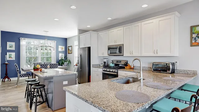 a kitchen with sink refrigerator and stove
