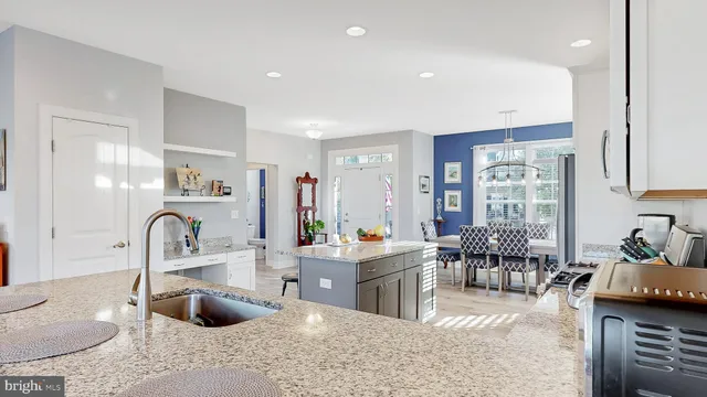 a kitchen with sink and view living room