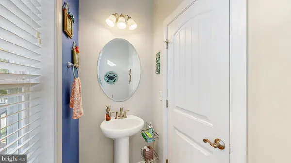 a bathroom with a sink mirror and toilet