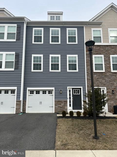 34 Rome Way Mount Laurel, NJ 08054 - Photo 1 of 25 a view of a brick house with many windows and a yard