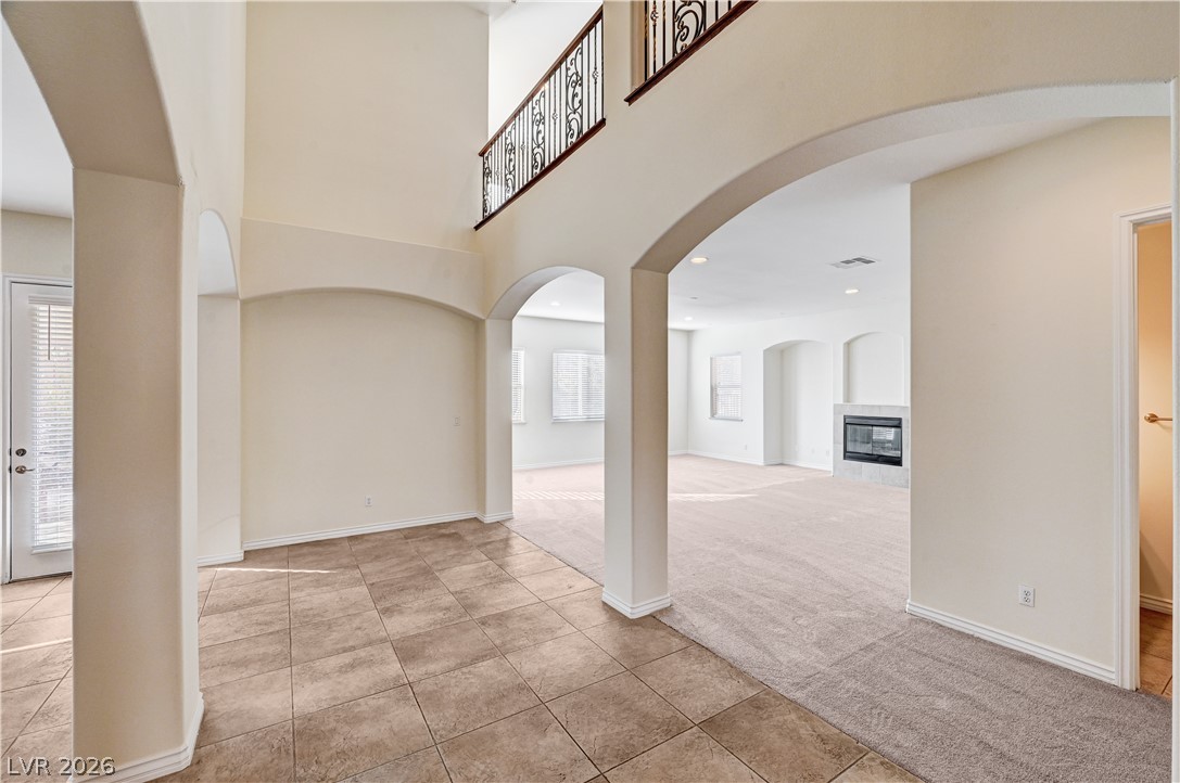 6761 Clay TABLET Street Las Vegas, NV 89149 - Photo 13 of 73 Elegant architectural archways define the transition between tiled and carpeted living areas.