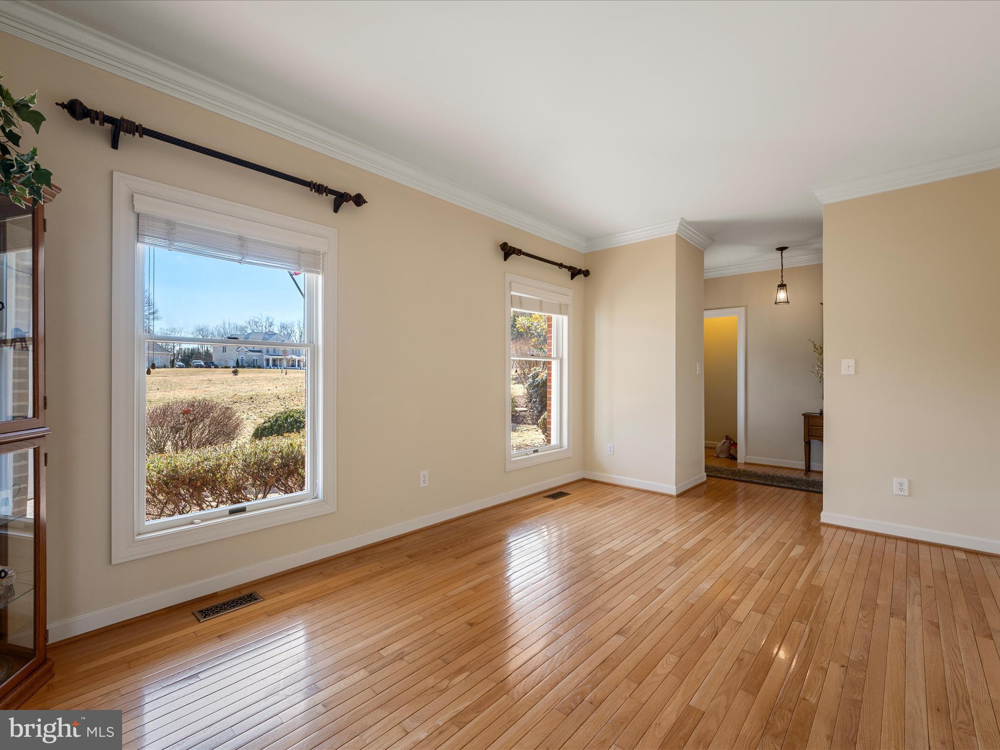 41950 Saddlebrook Place Leesburg, VA 20176 - Photo 18 of 87 a view of an empty room with wooden floor and a window