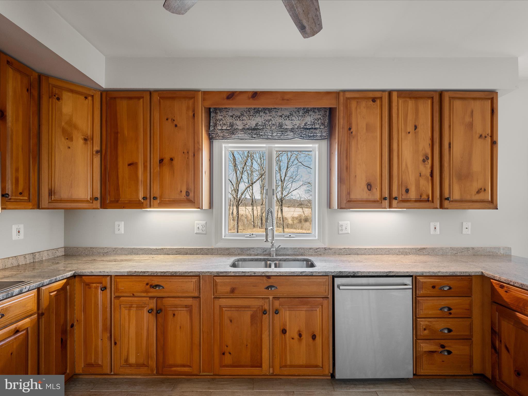 41950 Saddlebrook Place Leesburg, VA 20176 - Photo 26 of 87 a kitchen with granite countertop wooden cabinets a sink and dishwasher a stove with wooden floor