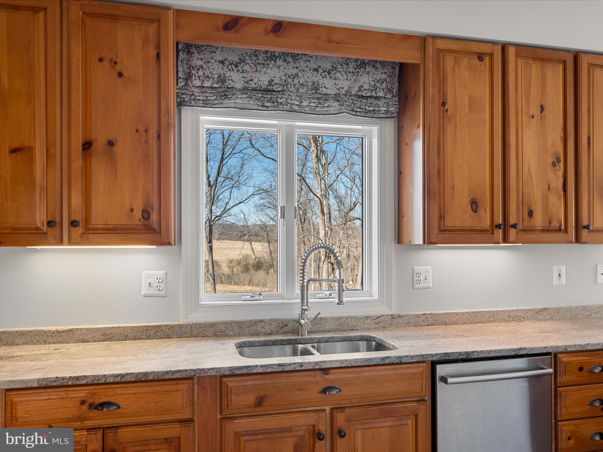 41950 Saddlebrook Place Leesburg, VA 20176 - Photo 27 of 87 a kitchen with granite countertop a sink window and cabinets