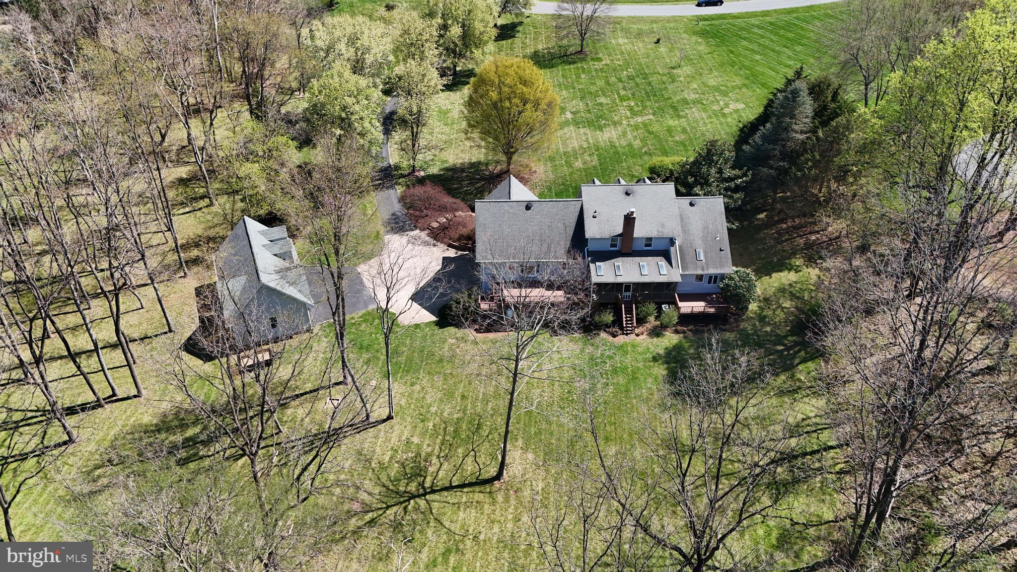 41950 Saddlebrook Place Leesburg, VA 20176 - Photo 86 of 87 an aerial view of a house with a yard and large tree