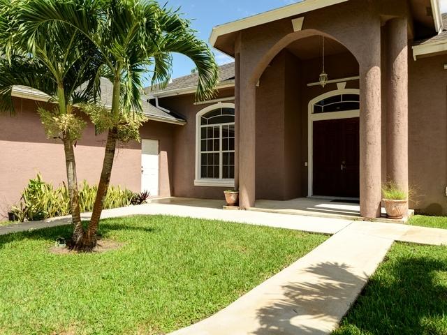 12557 154th Road North Jupiter, FL 33478 - Photo 1 of 38 a view of a house with a garden