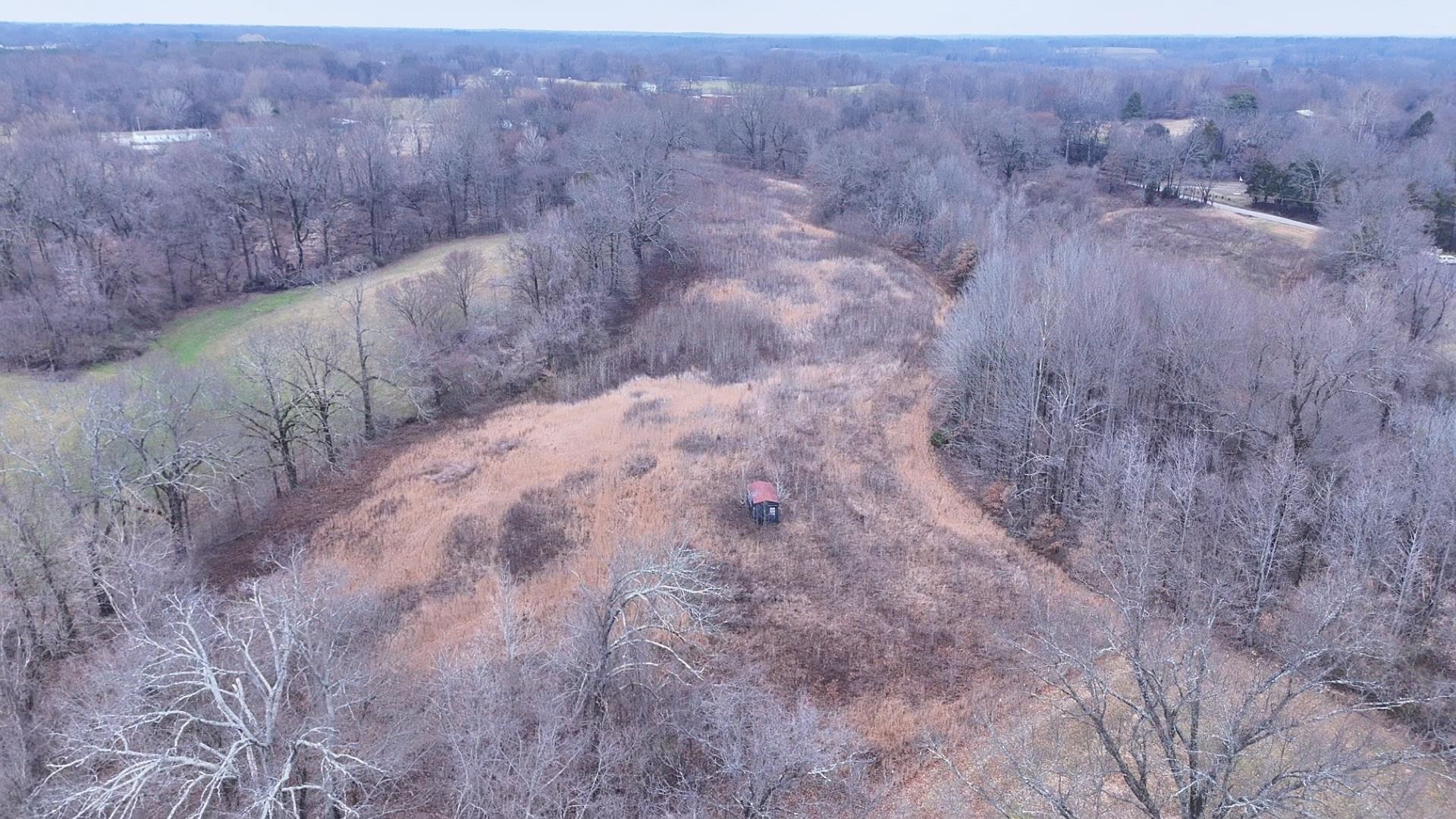 2375 Woodville Road Ripley, TN 38063 - Photo 1 of 1 Birds eye view of property featuring a wooded view