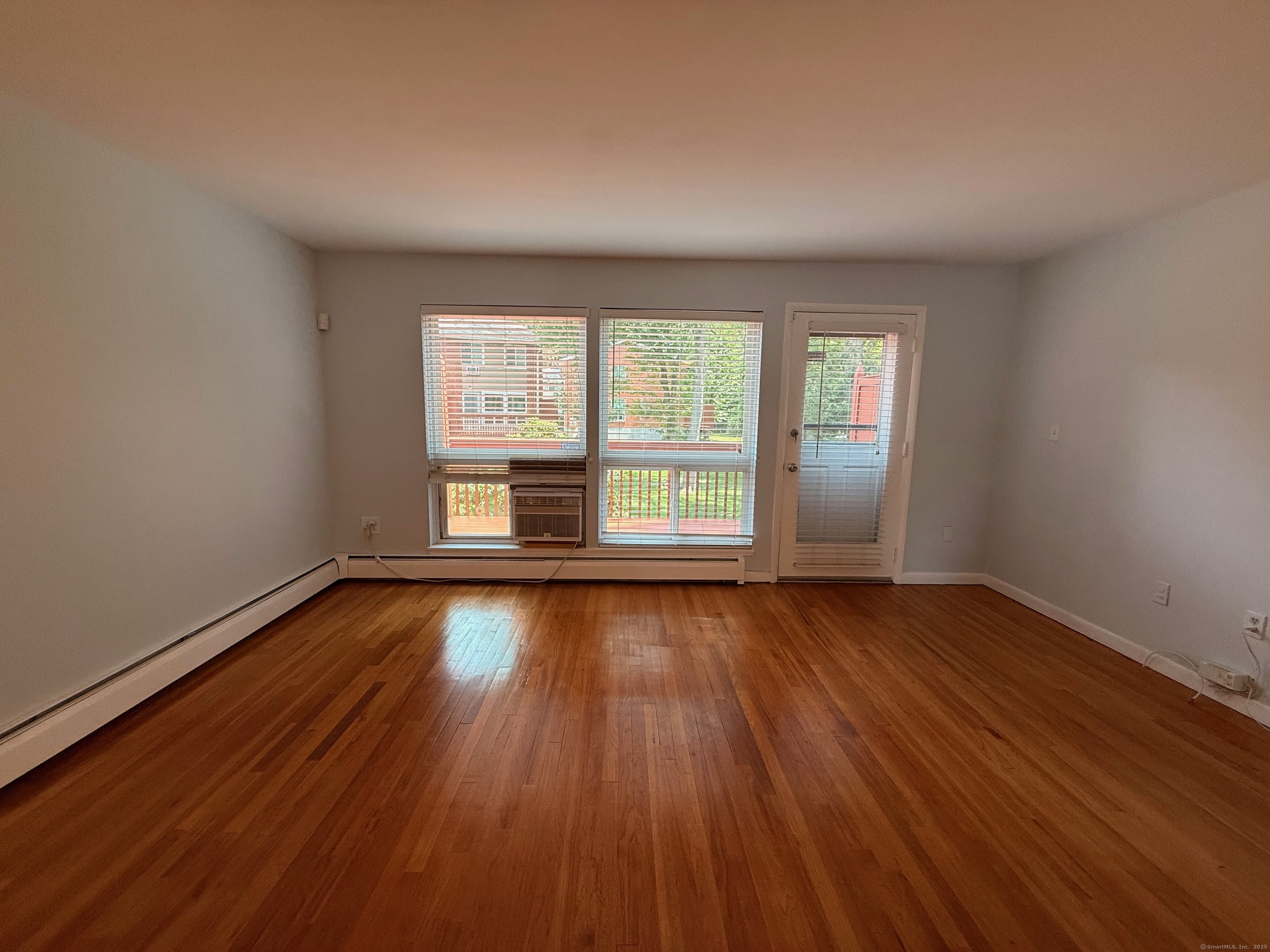 182 Worth Avenue Hamden, CT 06518 - Photo 12 of 36 a view of an empty room with wooden floor and window