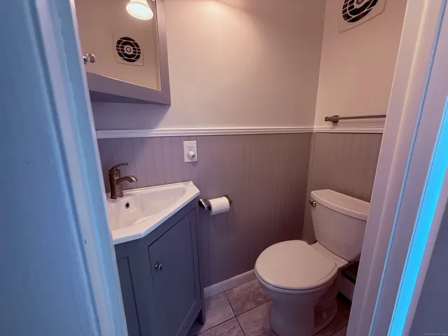 a bathroom with a sink a toilet and vanity