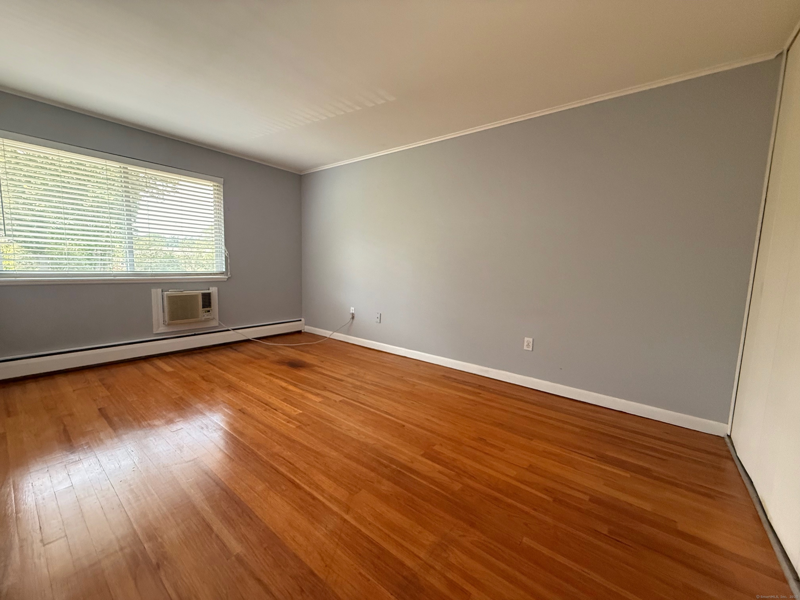 182 Worth Avenue Hamden, CT 06518 - Photo 18 of 36 an empty room with wooden floor and windows