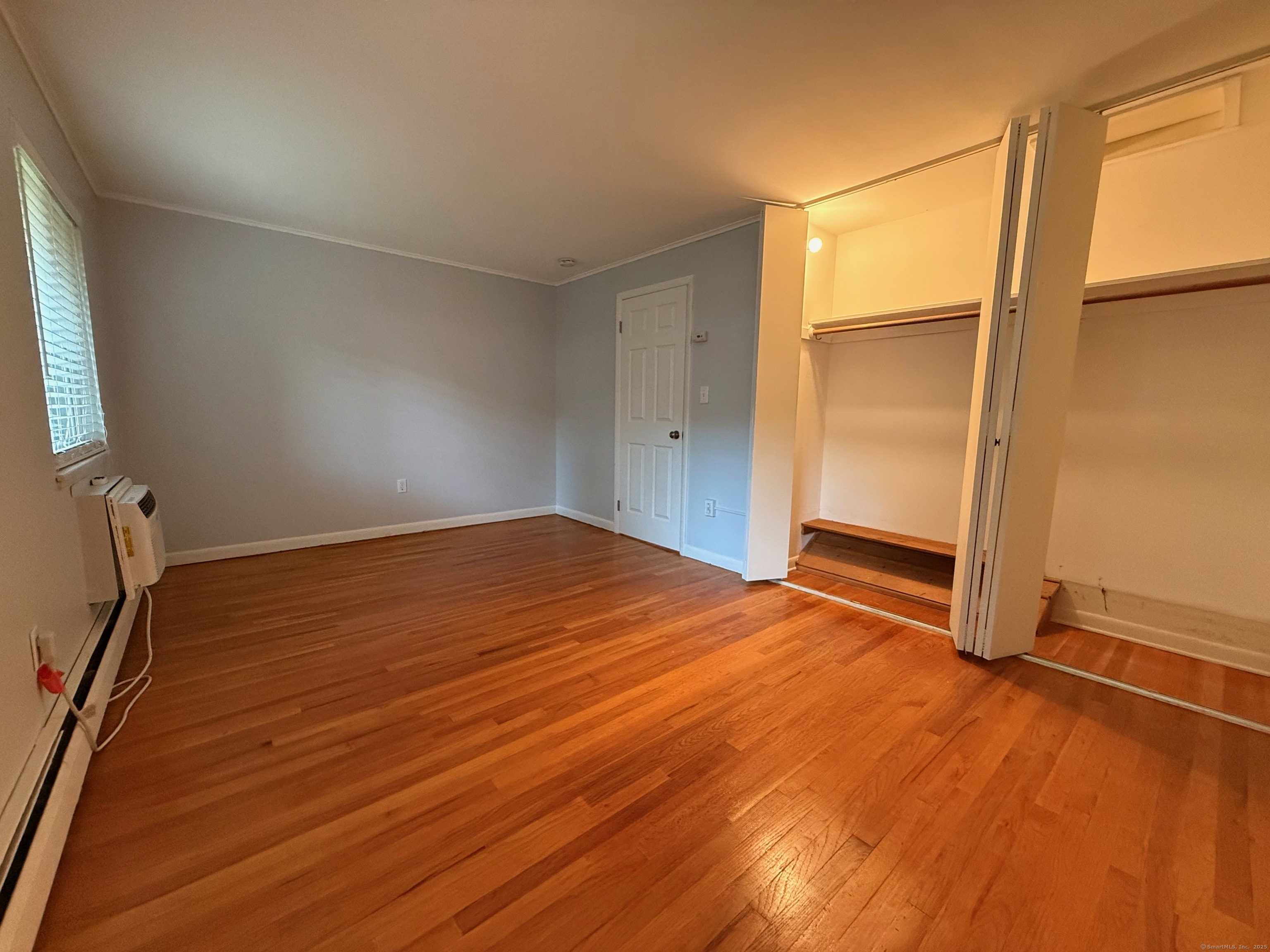 182 Worth Avenue Hamden, CT 06518 - Photo 23 of 36 an empty room with wooden floor and windows