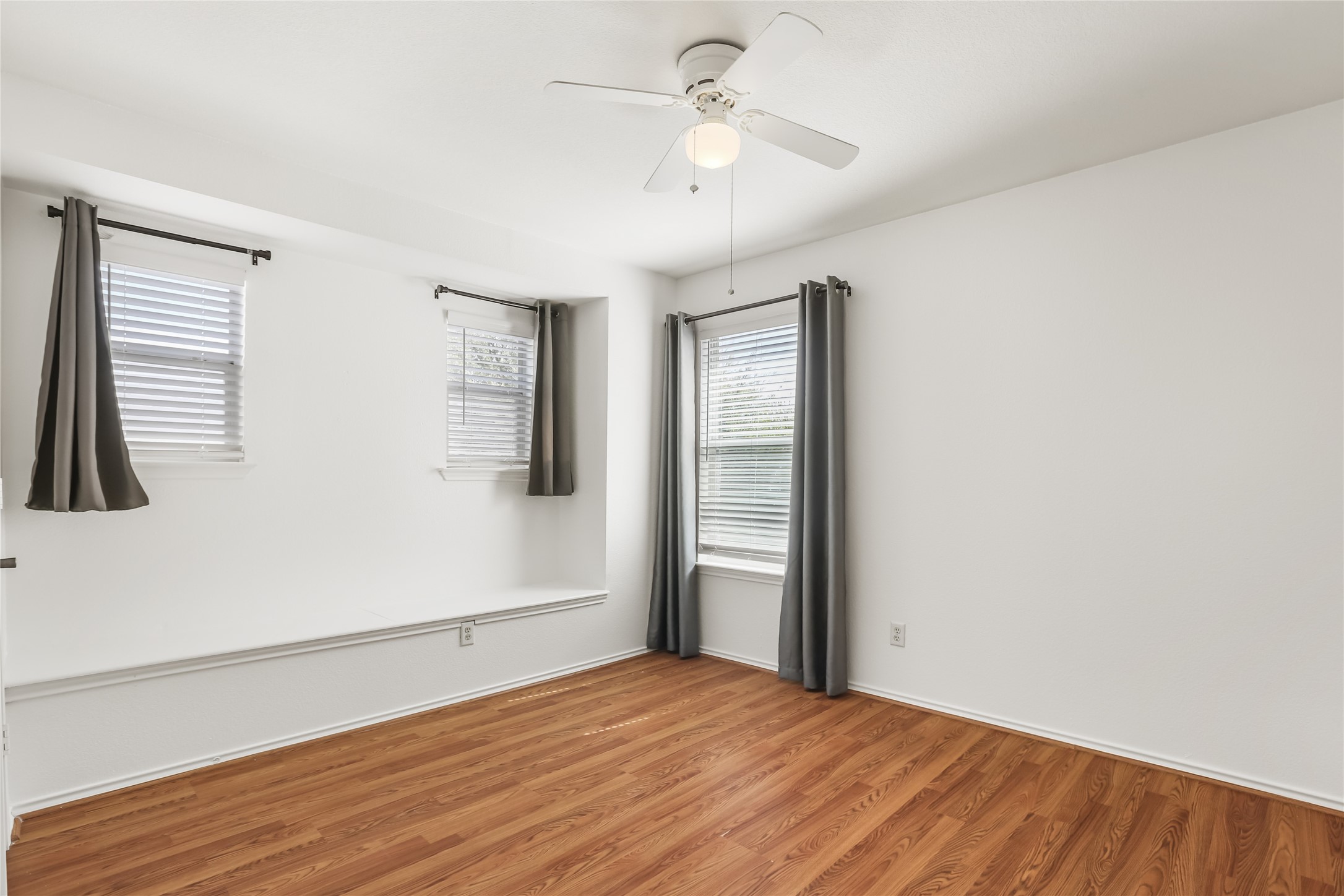 2010 Ashberry Trail Georgetown, TX 78626 - Photo 21 of 24 Unfurnished room with wood finished floors and a ceiling fan