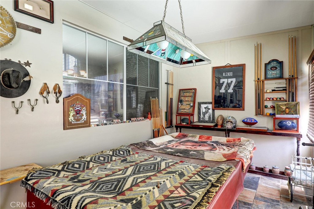 20895 Parish Place Riverside, CA 92508 - Photo 15 of 18 a bedroom with a bed and a chandelier