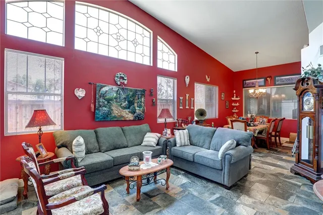 a living room with furniture a rug and a large window