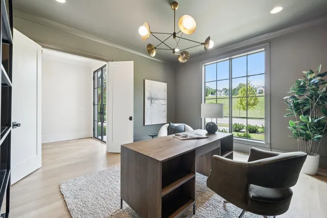 a dining hall with stainless steel appliances granite countertop a sink dishwasher and a flat tv screen next to a large window with wooden floor