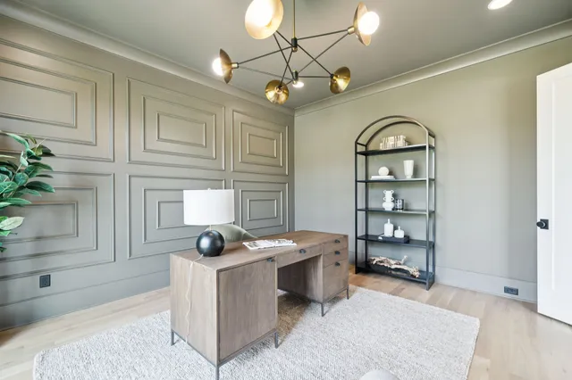 a kitchen with kitchen island granite countertop a sink cabinets and wooden floor