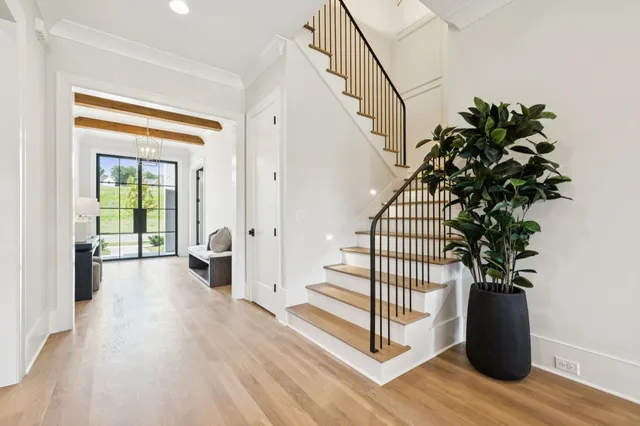 a kitchen with stainless steel appliances granite countertop a stove a sink dishwasher and a refrigerator with wooden floor