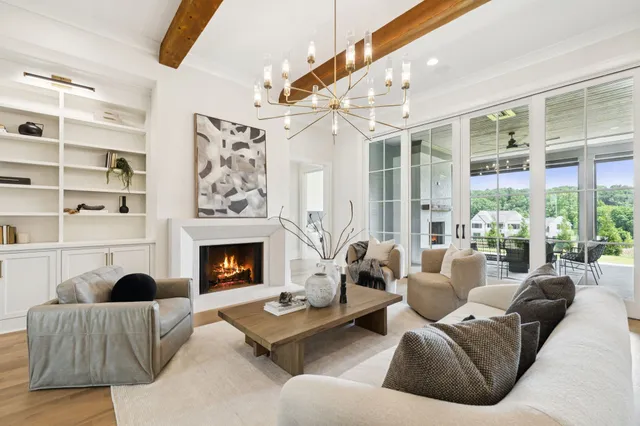 a large kitchen with kitchen island a large counter top a sink appliances and a large window