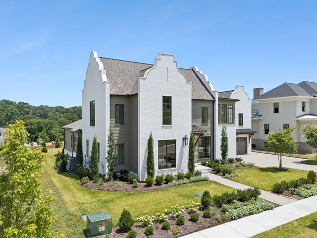 a view of a living room hardwood floor and a large window