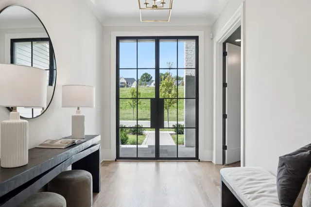 a living room with furniture a fireplace and a large window