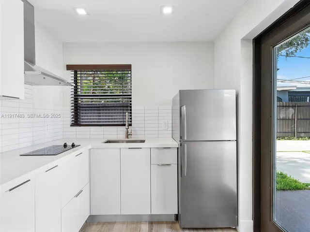 a white refrigerator freezer sitting inside of a kitchen