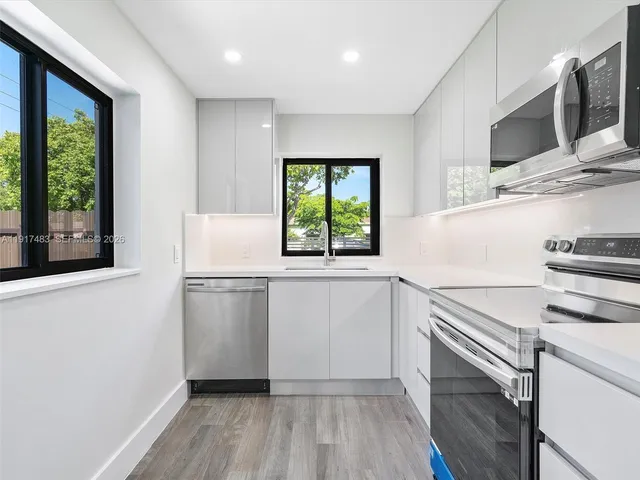 a kitchen with a refrigerator stove and microwave