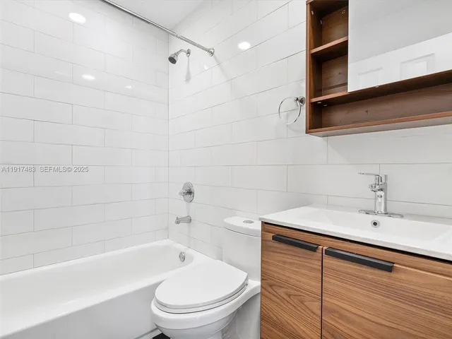 a bathroom with a sink a toilet and bathtub