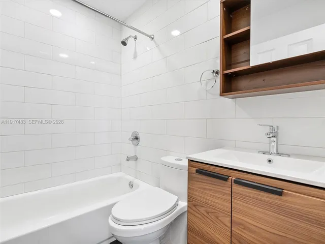 a bathroom with a sink a toilet and bathtub