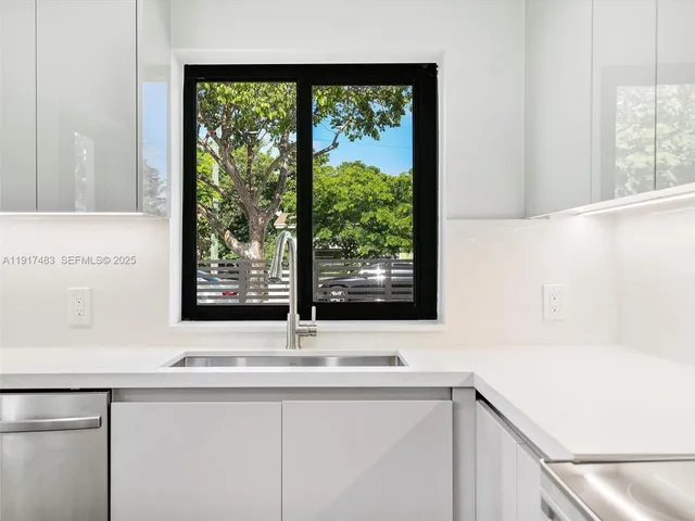 a view of a sink and a large mirror