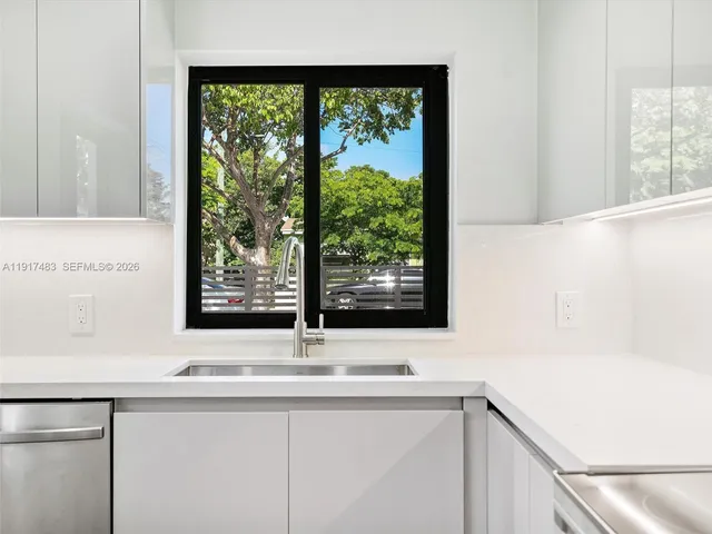 a view of a sink and a large mirror